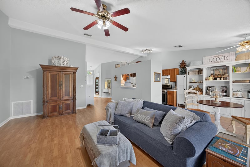 Living room with wood armoire and fireplace at 4556 Shaky Leaf Ln N, Jacksonville, FL 32224