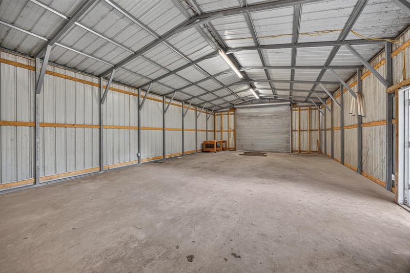 Interior of metal outbuilding with open space at 5843 Ovella Rd, Jacksonville, FL 32244