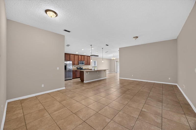 Open kitchen and living area with tile floor at 469 Glendale Ln, Orange Park, FL
