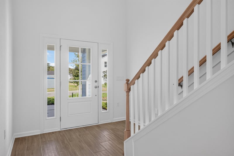 Entry foyer with glass front door and staircase at 269 Bluegrass Wy, St. Augustine, FL 32092