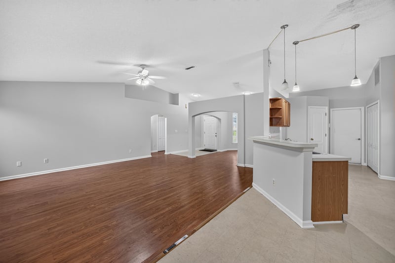 Open living area leading to kitchen bar at 9691 Nelson Forks Dr, Jacksonville, FL 32222
