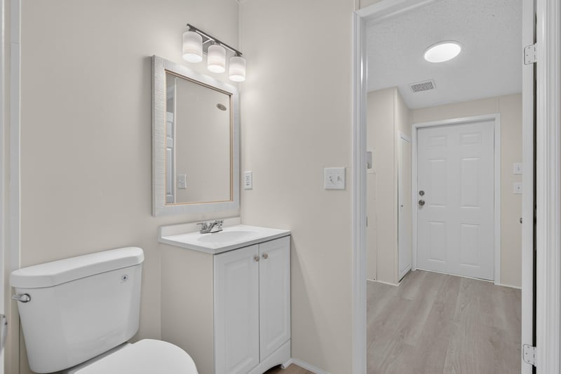 Bathroom vanity and mirror at 7603 Coach Park Dr, Jacksonville, FL 32244