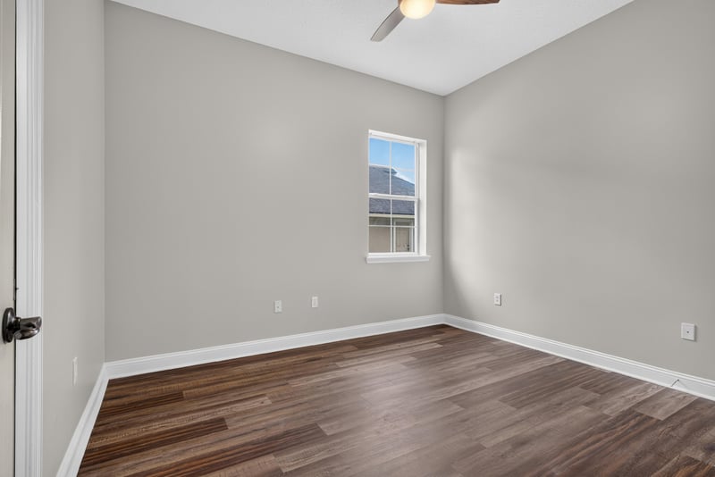 Bedroom with wood floor and single window at 4109 Eagle Landing Pkwy, Orange Park, FL 32065