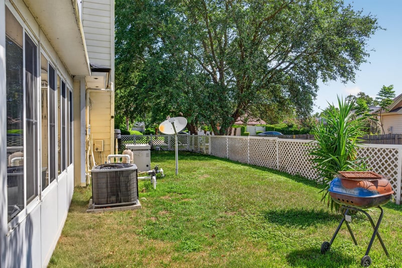 Backyard with grill and outdoor unit at 8680 Bandera Cir S, Jacksonville, FL 32244