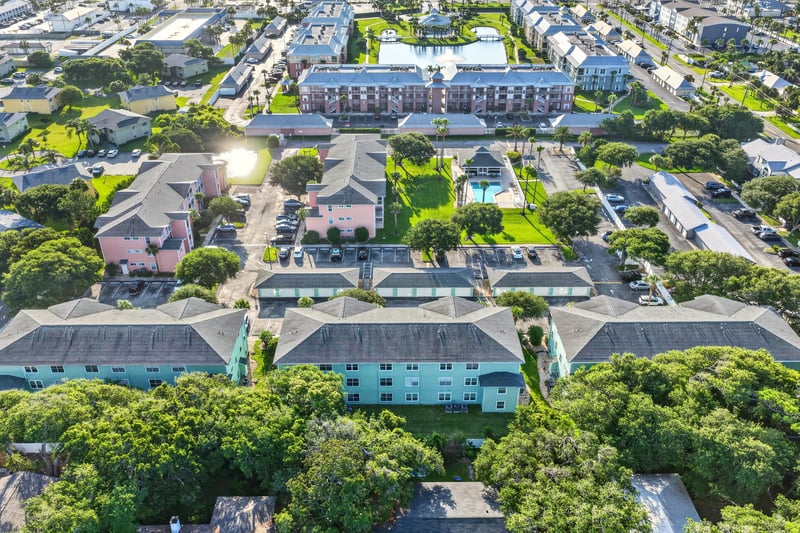Aerial view of pastel-colored condo rooftops and streets in St. Augustine, FL