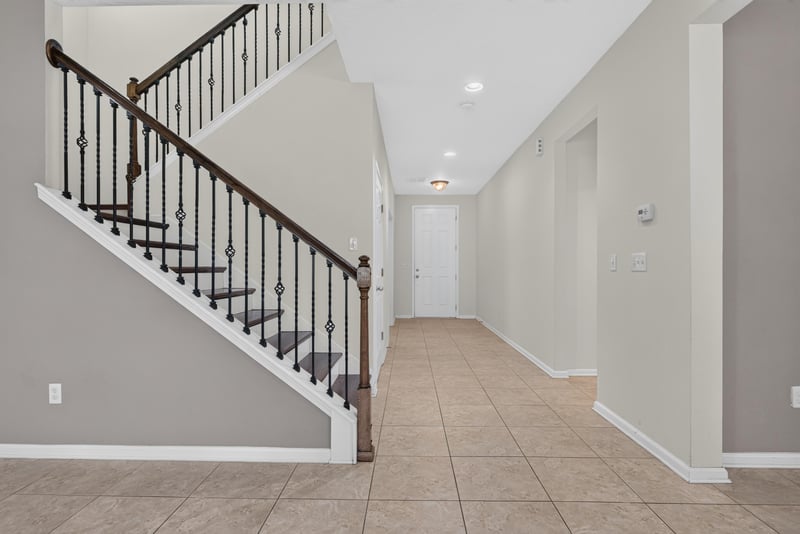 Staircase with wrought-iron railing and tile floor at 263 Gilmore Ln, Orange Park, FL 32065