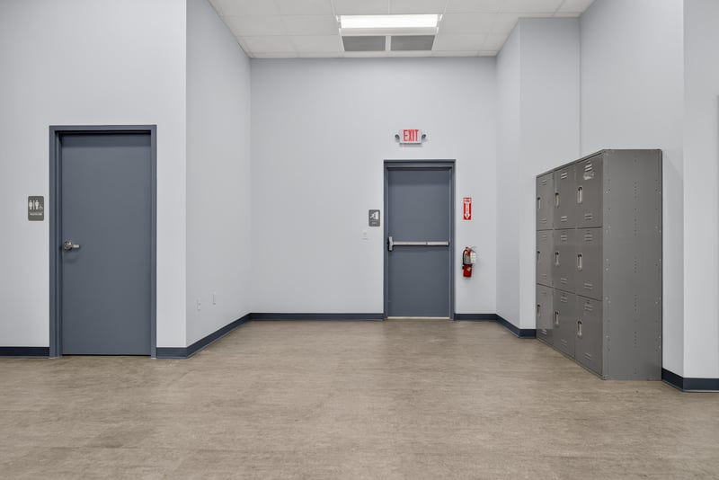 Hallway with exit sign, interior doors, and file cabinets at 7240 Golden Wings Rd building 100, Jacksonville, FL 32244
