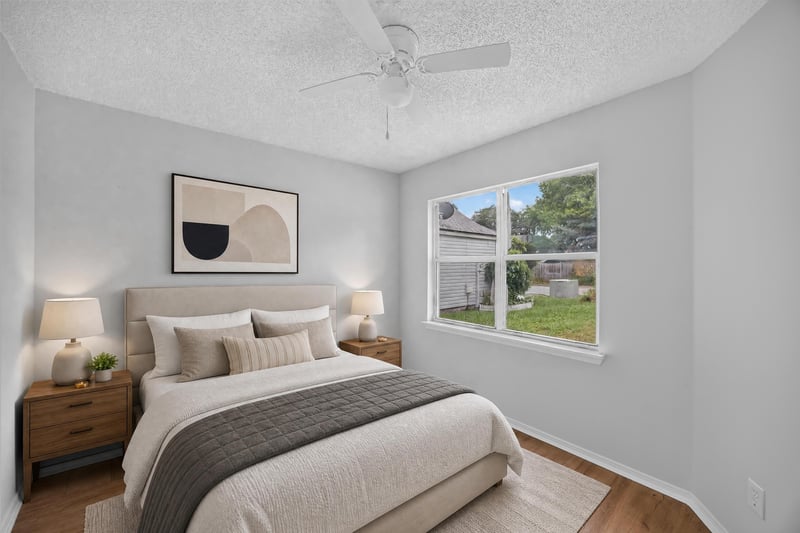Virtually staged bedroom with bed and artwork at 8047 Mactavish Way E, Jacksonville, FL 32244