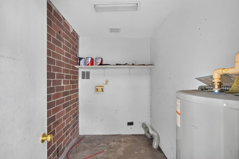 Laundry closet with exposed brick wall at 2658 Trollie Ln apt 1, Jacksonville, FL 32211