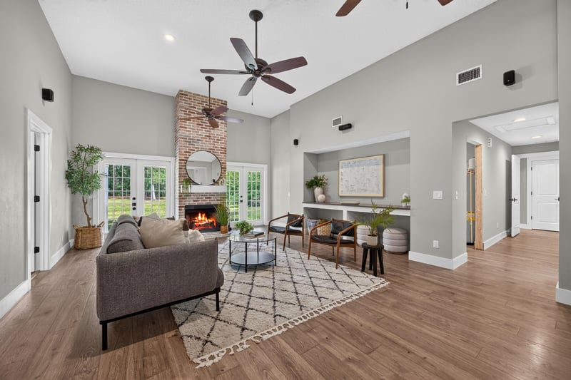 Living room with brick fireplace and ceiling fan at 1161 Whispering Pines Rd, Jacksonville, FL 32259