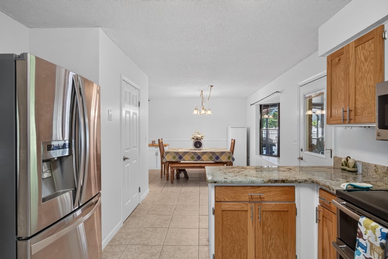 Kitchen opening to dining area at 2435 Range Line Rd, Middleburg, FL