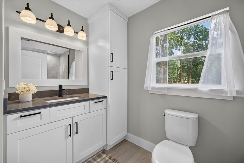 Bathroom vanity with mirror and window at 1161 Whispering Pines Rd, Jacksonville, FL 32259
