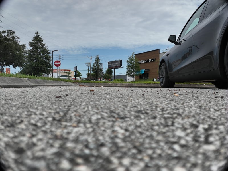 Ground-level view of entry road and business sign at 9406 Atlantic Blvd, Jacksonville, FL 32225