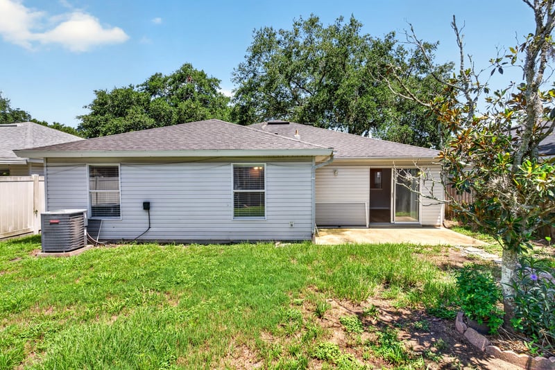 Backyard with grass and AC unit at 1108 Hidden Cove Cir S, Atlantic Beach, FL 32233