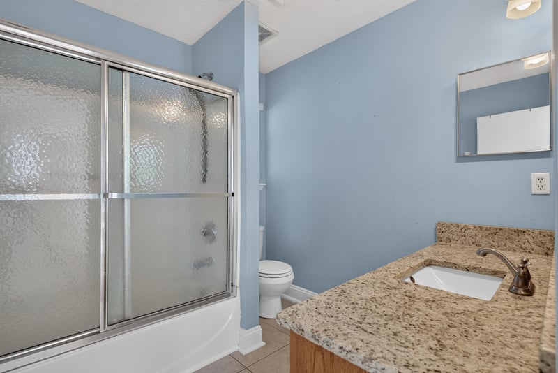 Bathroom with glass shower and granite vanity at 353 Redwood Ln