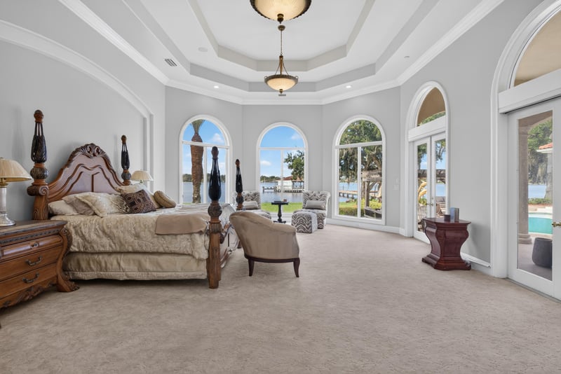 Primary bedroom with four-poster bed and arched windows at 344 Broward Rd, Jacksonville, FL