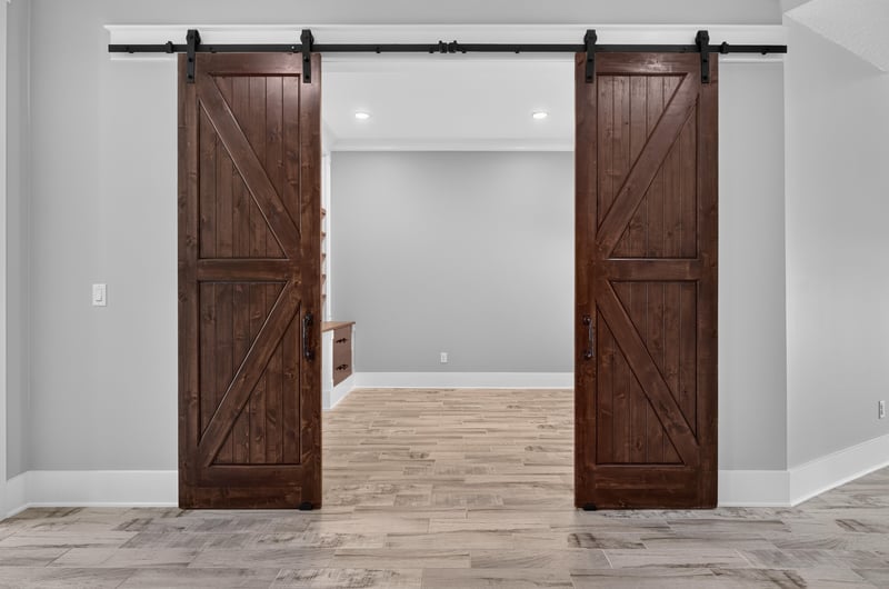 Dark wood barn doors opening to a flex room at 186 Freshwater Dr