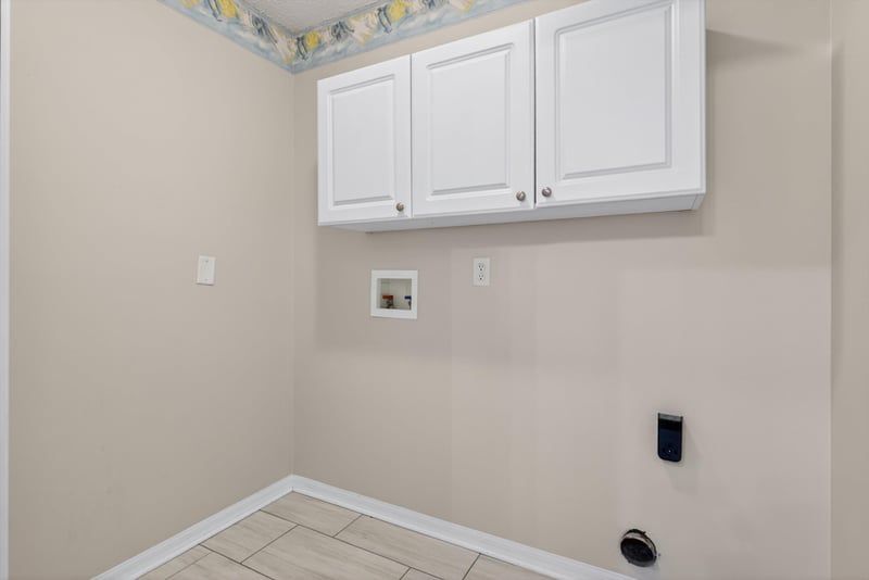 Laundry room cabinets and utility hookups at 1648 Glen Laurel Dr, Middleburg, FL 32068