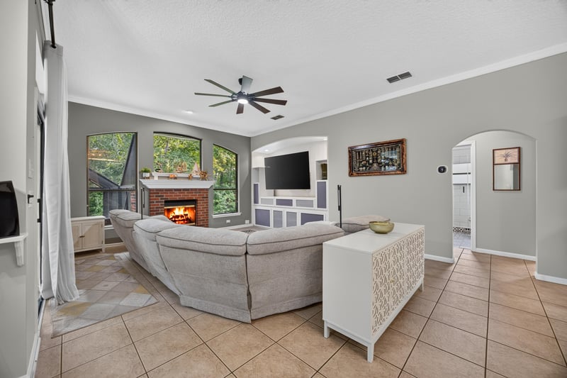 Living room with fireplace and wall-mounted TV at 2125 Blue Heron Cove Dr, Orange Park, FL 32003