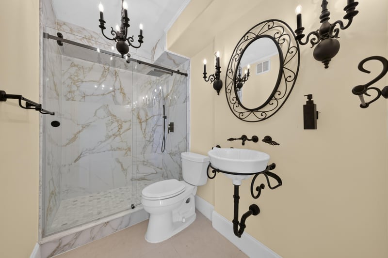 Bathroom with marble shower and ornate mirror at 1301 1st St S