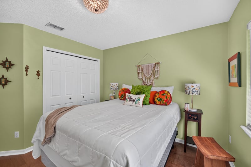 Bedroom with green walls and closet at 1820 Burgess Hill Dr E, Jacksonville, FL
