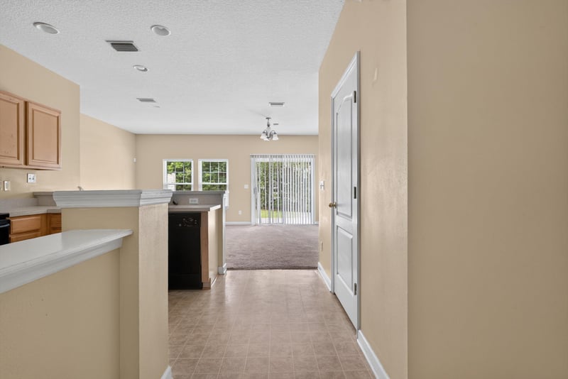 Kitchen peninsula open to living room at 12359 Mangrove Forest Ct, Jacksonville, FL 32218