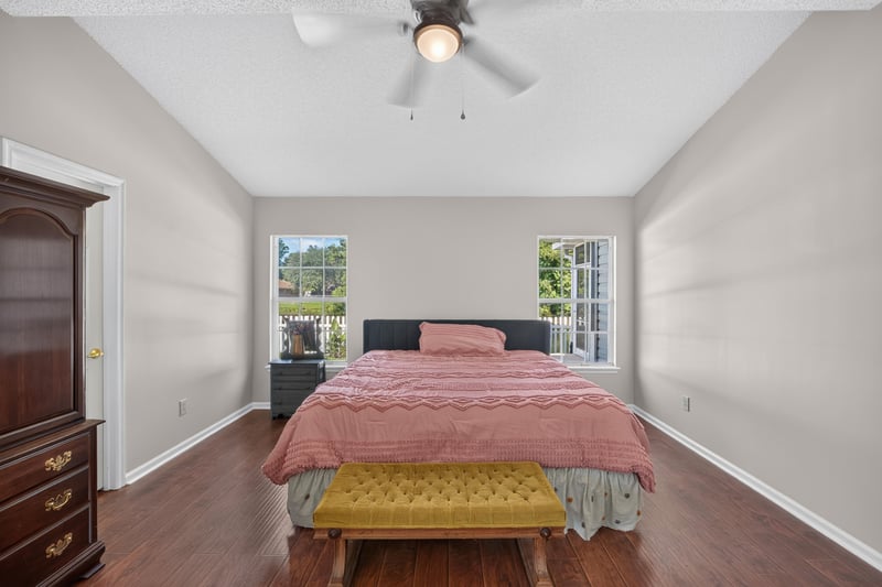 Primary bedroom with bed and dresser at 11828 Heather Grove Ln, Jacksonville, FL