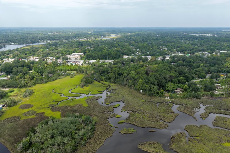 Aerial view of marsh channels and distant neighborhood at 1818 Elm St, Jacksonville, FL 32208