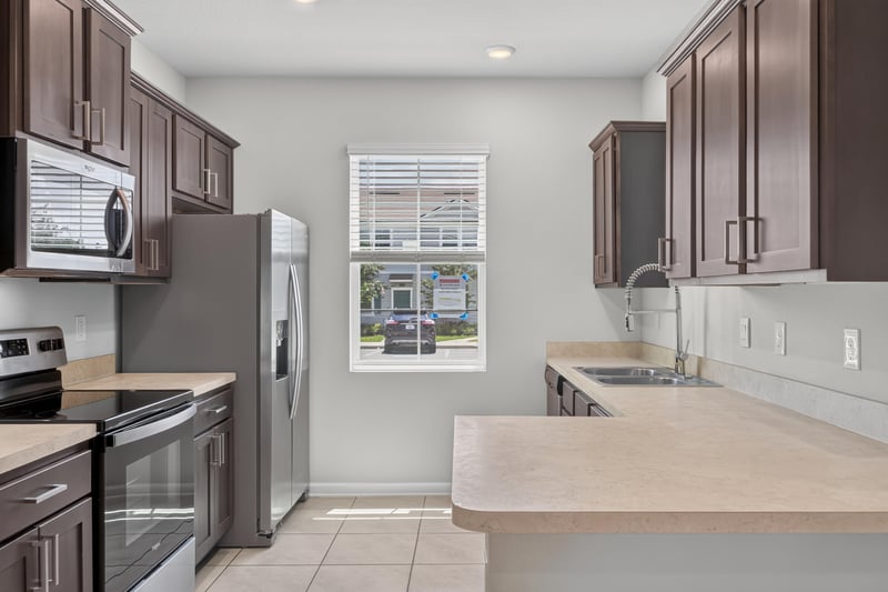 Kitchen with dark cabinets and stainless microwave at 2837 Black Buck Cir, Jacksonville, FL 32225