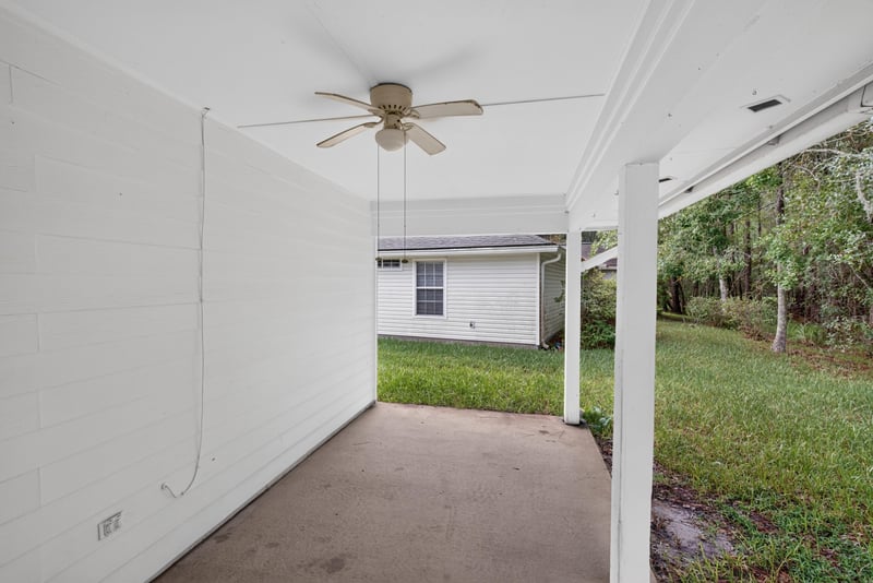 Covered back porch with ceiling fan at 11669 Collins Creek Dr, Jacksonville, FL 32258