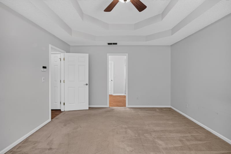 Empty room with two doors and carpet flooring at 2480 Ridge Will Dr, Jacksonville, FL 32246