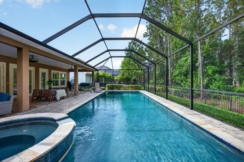 Pool and lanai view toward wooded backyard at 276 Cross Ridge Dr, Ponte Vedra Beach, FL 32081