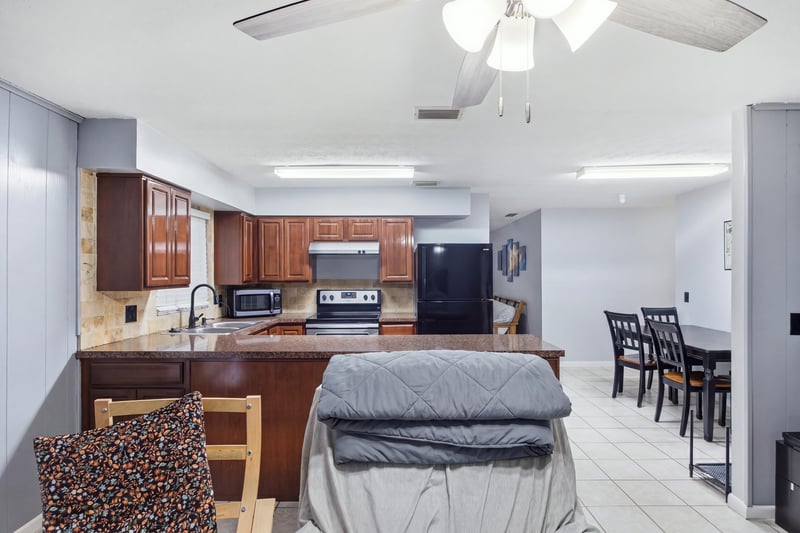 Kitchen with bar seating and stainless stove at 417 Capricorn Ln, Orange Park, FL 32073