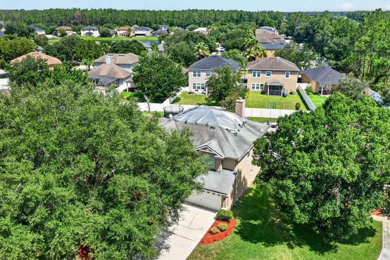 Aerial view of the home among neighborhood trees at 3660 Middlebrook Dr, Orange Park, FL 32065
