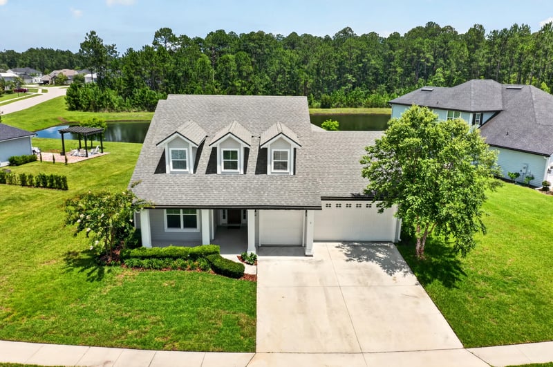 Front exterior with dormers, landscaped yard and driveway at 53 Lumen Ct, St. Augustine, FL 32095