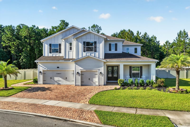 Front exterior in daylight, white siding and black shutters at 22 Azura Point