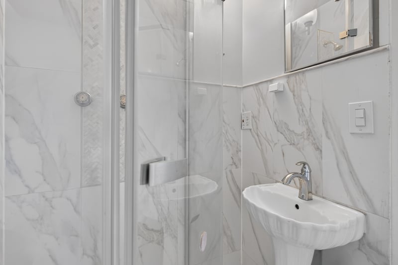 Bathroom with pedestal sink and tile walls at 217 Baisden Rd, Jacksonville, FL 32218