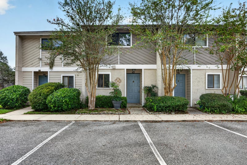 Front entrance with blue door and landscaping at 3801 Crown Point Rd, Jacksonville, FL 32257