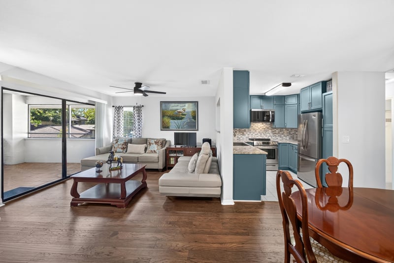 Living room with kitchen pass-through and sofa at 10150 Belle Rive Blvd, Jacksonville, FL