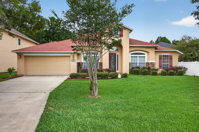 Front exterior with tile roof and driveway at 635 Wakeview Dr, Orange Park, FL 32065