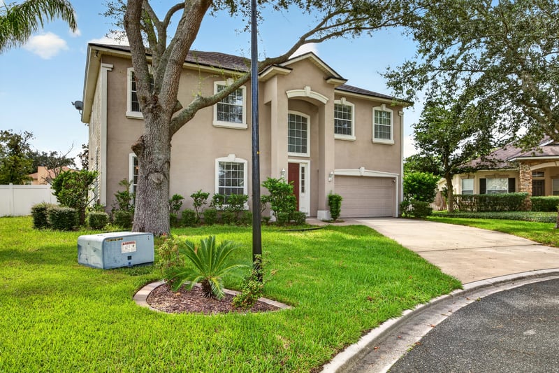 Front exterior with mailbox and landscaping at 2875 Pebblewood Ln, Orange Park, FL 32065
