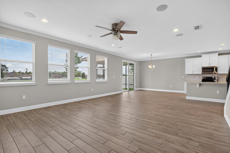 Living room corner with ceiling fan and windows at 2580 Cold Stream Ln, Green Cove Springs, FL 32043