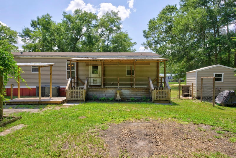 Rear exterior with pergola-covered porch at 2549 Snapdragon Ave, Middleburg, FL 32068
