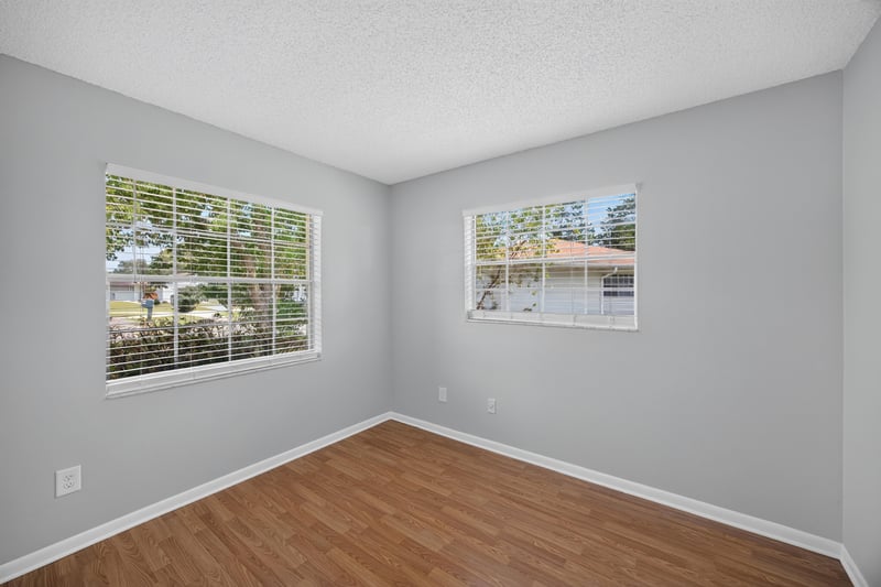 Bedroom with two windows and wood laminate floor at 328 Palos Ct, St. Augustine, FL