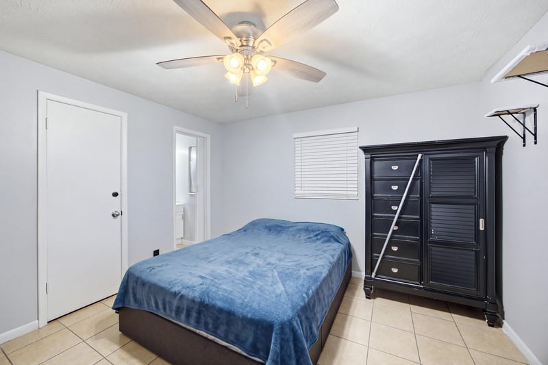 Bedroom with dark furniture and blue bedding at 417 Capricorn Ln, Orange Park, FL 32073