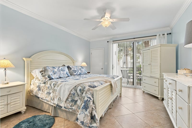 Bedroom with four-poster bed and sliding doors at 805 Spinnakers Reach Dr, Ponte Vedra Beach, FL 32082