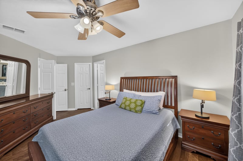 Bedroom with bed, dresser, and mirror at 10150 Belle Rive Blvd, Jacksonville, FL