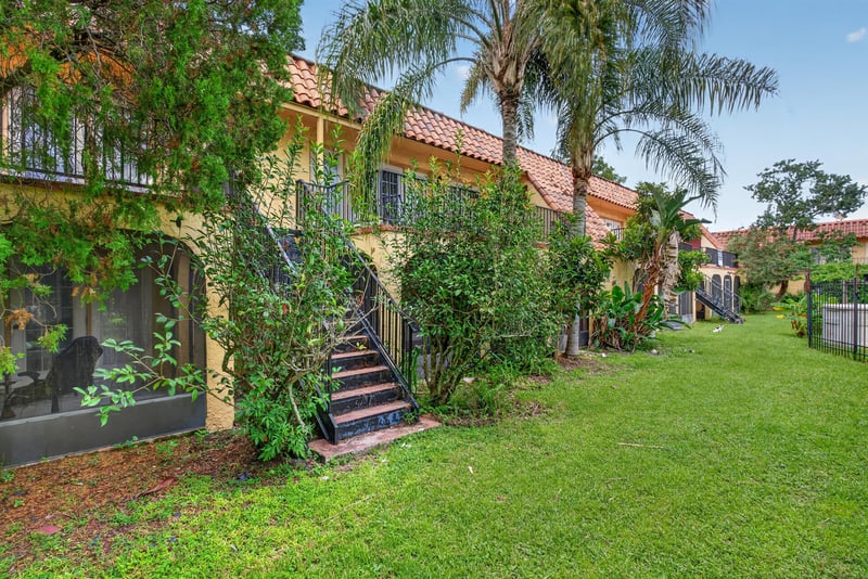 Rear exterior with greenery and building wall at 3866 Campenero Ct unit 6, Jacksonville, FL 32217