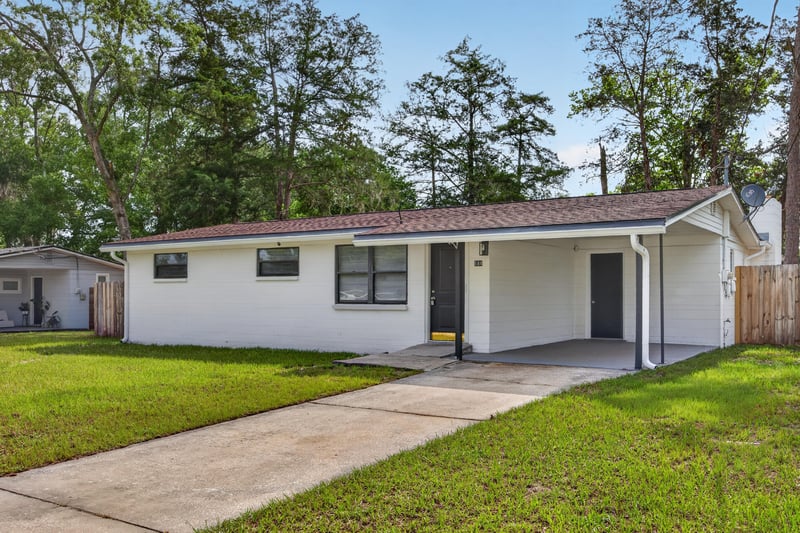 Front exterior, covered entry and white brick siding at 184 Draco St, Orange Park, FL 32073