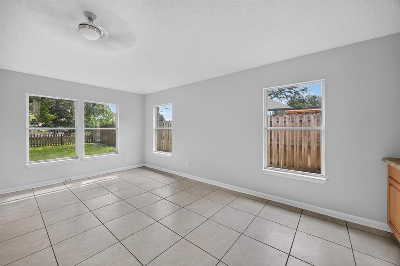 Tile-floor room with windows overlooking yard at 456 Bay Point Way N, Jacksonville, FL 32259